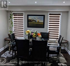 Brampton (Fletcher's Meadow) apartment for rent - A dining room with a table set for four and a painting on the wall.