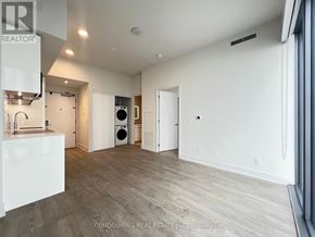 Toronto (Annex) condo for rent - A spacious room with a washer and dryer in it.