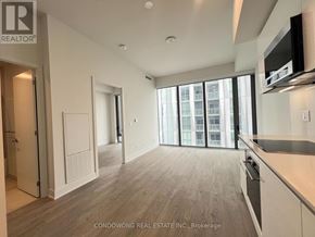 Toronto (Annex) condo for rent - A spacious, well-lit condo with wood flooring and large windows.