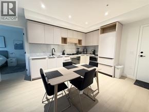 Port Moody apartment for rent - A modern kitchen with a dining table set up with four chairs.