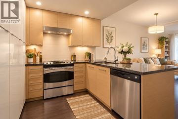 Vancouver apartment for rent - A modern kitchen with wooden cabinets and stainless steel appliances.