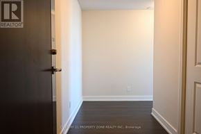 Toronto (Markland Wood) condo for rent - A hallway with a door on the left and a wall on the right.