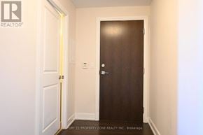 Toronto (Markland Wood) condo for rent - A hallway with a brown door and a white door on the left.