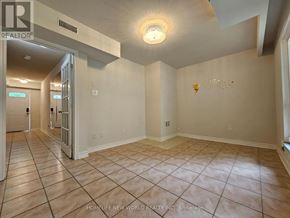 Toronto (Hillcrest Village) townhouse for rent - A spacious room with tiled flooring and a ceiling light fixture.