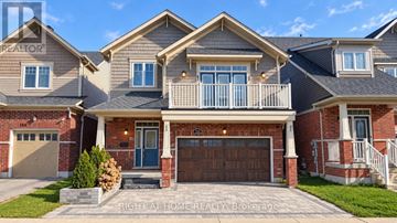 Oshawa (Windfields) apartment for rent - A large house with a garage and a balcony.