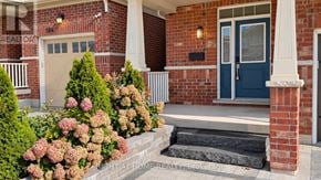 Oshawa (Windfields) apartment for rent - A house with a blue door and a brick wall.