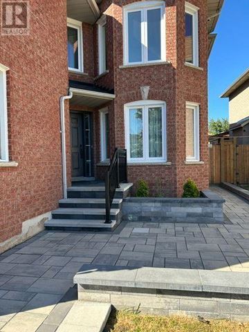 Mississauga (Hurontario) apartment for rent - A brick house with a black door and steps leading to the entrance.