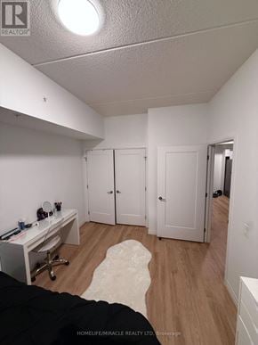 London East (East K) condo for rent - A bedroom with a desk and a bed.