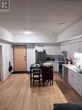 London East (East K) condo for rent - A kitchen with a table and chairs in the middle of the room.