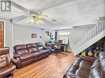 London South (South Y) apartment for rent - A living room with brown leather couches and a white ceiling fan.