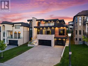 Niagara-On-The-Lake (St. Davids) apartment for rent - A modern house with a large driveway is shown in the image.