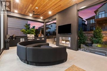 Niagara-On-The-Lake (St. Davids) apartment for rent - A modern living room with a large black sofa and a flat screen TV.