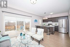 Niagara Falls (Forestview) apartment for rent - A modern kitchen with a glass table and chairs, and a view of a deck outside the window.
