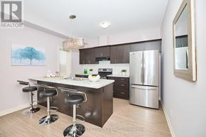 Niagara Falls (Forestview) apartment for rent - A kitchen with a bar area and a refrigerator.