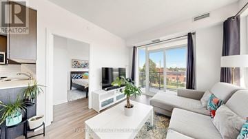 Toronto (Henry Farm) condo for rent - A living room with a grey couch and a white coffee table.