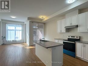 Markham (Wismer) townhouse for rent - A kitchen with white cabinets and a granite countertop.