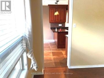 Newmarket (Gorham-College Manor) apartment for rent - A kitchen with wooden cabinets and a tiled floor.