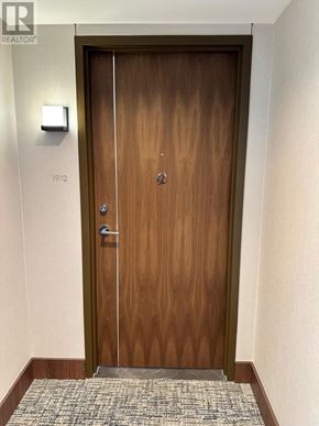 Toronto (Waterfront Communities) condo for rent - A wooden door with a glass panel and a handle.