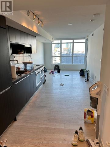 Toronto (Waterfront Communities) condo for rent - A kitchen with a black counter top and a white wall.