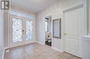 Aurora apartment for rent - A bathroom with a toilet, sink, and double doors with decorative glass.