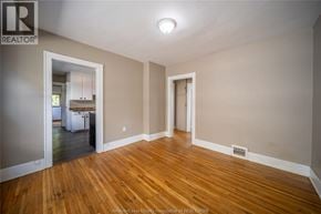 Windsor apartment for rent - A room with wooden floors and a white door.