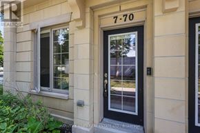 Toronto (Bridle Path-Sunnybrook-York Mills) townhouse for rent - A beige house with a black door and window with the number 7-70 on it.