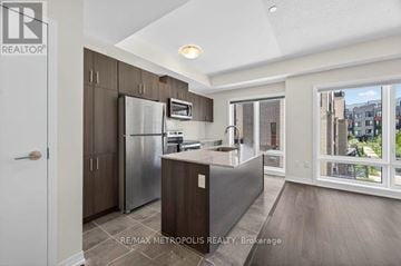 Toronto (Malvern) townhouse for rent - A modern kitchen with dark wood cabinets and stainless steel appliances.