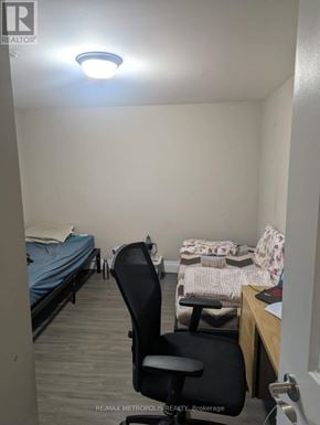 Toronto (Dorset Park) apartment for rent - A bedroom with a bed, chair, and desk.