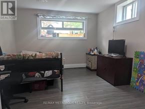 Toronto (Dorset Park) apartment for rent - A bedroom with a bed, desk, and window.