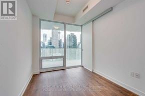 Toronto (Waterfront Communities) condo for rent - A room with a view of the city through a glass door.