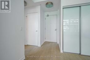 Toronto (Waterfront Communities) condo for rent - A white door is in a room with a wooden floor.