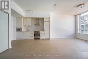 Toronto (Waterfront Communities) condo for rent - A spacious kitchen with white cabinets and a wooden floor.