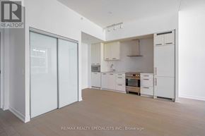 Toronto (Waterfront Communities) condo for rent - A white kitchen with a stove top oven and a refrigerator.