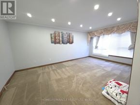 Toronto (West Humber-Clairville) apartment for rent - A room with a carpeted floor and a window with curtains.