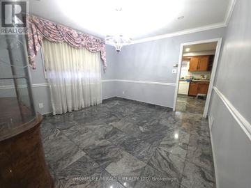 Toronto (West Humber-Clairville) apartment for rent - A spacious room with a marble floor and a kitchen visible in the background.
