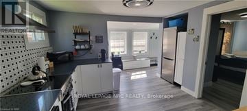Fort Erie (Crystal Beach) apartment for rent - A kitchen with a black counter top and white cabinets.