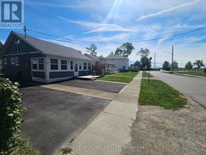 Fort Erie (Crystal Beach) apartment for rent - A sunny day in Brokerage with a building and a sign for Royal LePage NRG Realty.