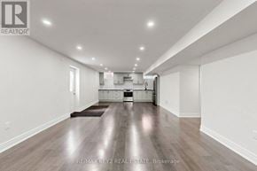 Pickering apartment for rent - A spacious room with a kitchen area in the background.