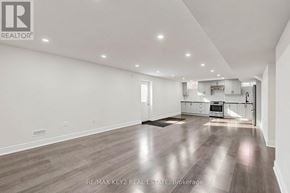 Pickering apartment for rent - A spacious room with wooden flooring and white walls.