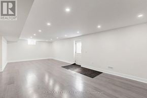 Pickering apartment for rent - A spacious room with a wooden floor and white walls.