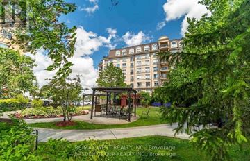 Vaughan (Lakeview Estates) condo for rent - A lush green park with a gazebo and a large building in the background.