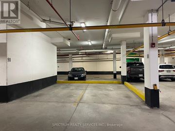 Vaughan (East Woodbridge) townhouse for rent - A parking garage with a black car parked in the middle.