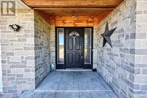 Essa apartment for rent - A black door is at the end of a stone wall.