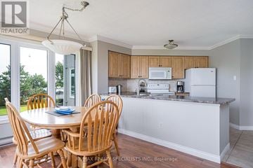 Collingwood condo for rent - A kitchen with a table and chairs in front of a window.