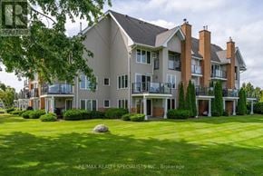 Collingwood condo for rent - A large, multi-story residential building with a lawn in front.