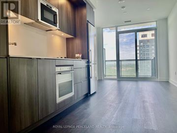 Toronto (Banbury-Don Mills) condo for rent - A modern kitchen with wooden cabinets and a stainless steel oven.