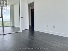 Toronto (Banbury-Don Mills) condo for rent - A room with a sliding glass door and a wooden floor.