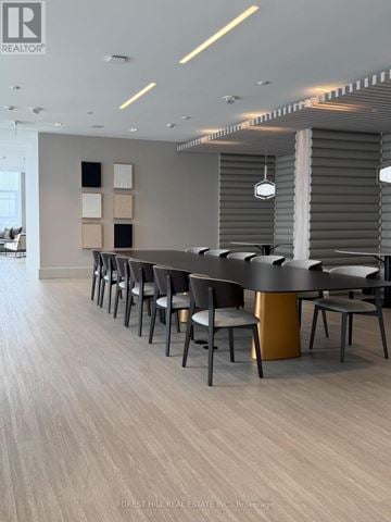 Toronto (Humewood-Cedarvale) condo for rent - A modern dining room with a long table and chairs.