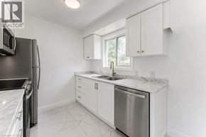 Cambridge apartment for rent - A kitchen with white cabinets and a marble countertop.