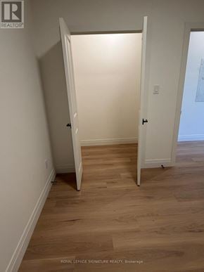 Toronto (Briar Hill-Belgravia) apartment for rent - A white door is open to a room with wooden floors.